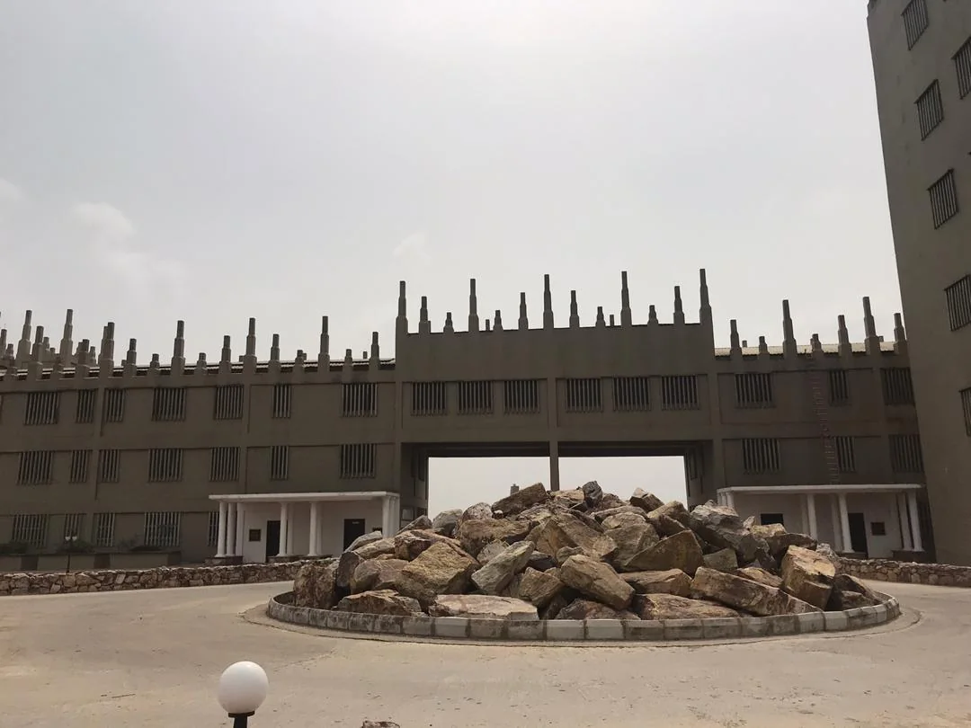The grey Anagkazo gatehouse under an overcast sky